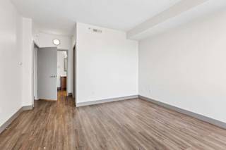 A room with wooden floors and white walls.