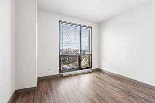A room with a large window overlooking a cityscape.
