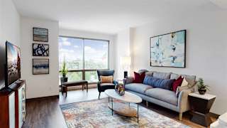 Enjoy the scenic views from the floor-to-ceiling windows in the living area of a 1 bedroom floor plan at Midtown Crossing Apartments Omaha