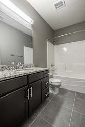 Bathroom with spacious vanity for storage and granite counters
