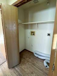 a laundry closet with washer and dryer hookups