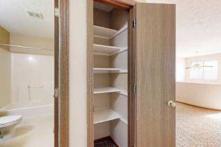 A linen closet in the loft are with built in shelves.