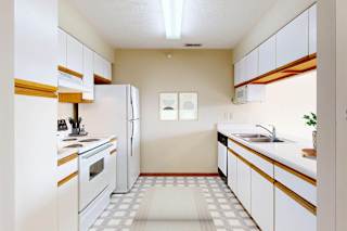 A kitchen with white appliances and wooden accents.