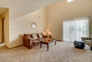 a living room with a couch coffee table and a window