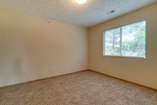 A room with a carpeted floor and a window.