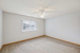 A room with a window and a ceiling fan.