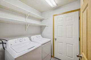 A small laundry room with a washer and dryer.
