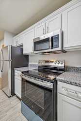 A kitchen with a stove top oven and microwave above it.
