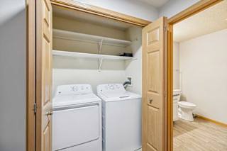 A small laundry room with a washer and dryer.