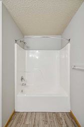 A white bathroom with a walk-in shower.