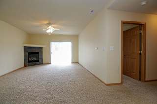 A room with a fireplace and a ceiling fan.