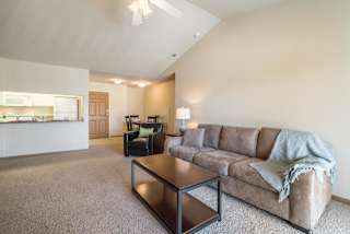 A living room with a couch, chair, and coffee table.