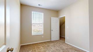 a bedroom with a closet and a tall window