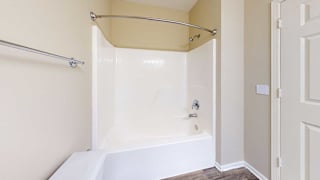 a bathroom with a combo tub shower