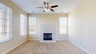 cozy living room with a modern tiled fireplace and large windows