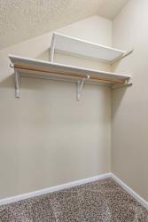 A white shelf is mounted on a wall.