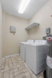 A small utility room with a washer and dryer.