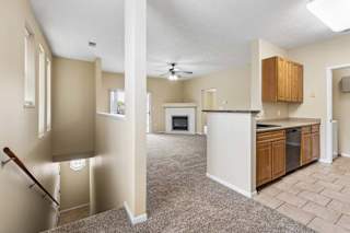 A spacious living area with a staircase leading to the upper floor.