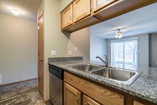 A kitchen with granite countertops and stainless steel appliances.
