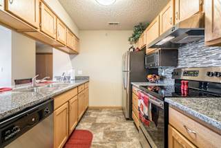 A kitchen with granite countertops and stainless steel appliances.