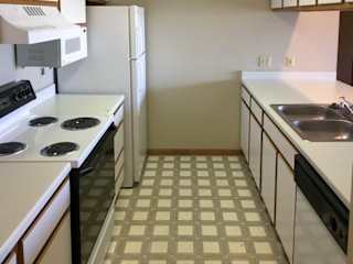 a kitchen with white appliances and white and brown cabients