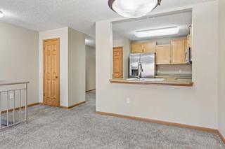 Dining area with kitchen pass-through and open loft-style layout.