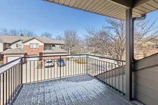 Private covered balcony overlooking the community and parking area.