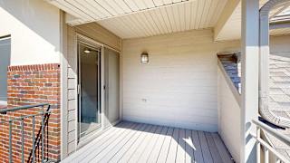 a balcony with an awning and exterior light