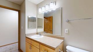 a bathroom with a vanity sink and a mirror with overhead lighting