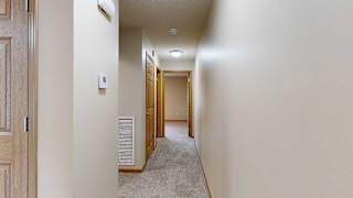 a hallway with carpet and several doors