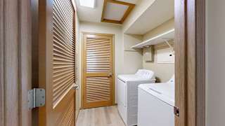 a laundry room with a washer and dryer and a wooden door