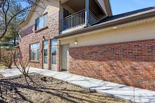 Ground-level apartment patio with brick exterior and private entry.