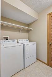 In-unit laundry area with side-by-side washer and dryer.