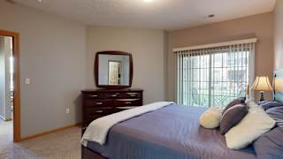 a bedroom with a bed and a dresser with a mirror