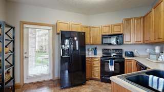 a kitchen with wood cabinets and black appliances