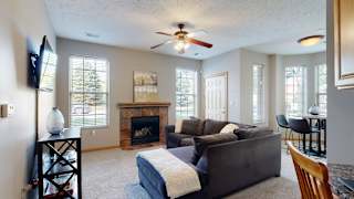 a living room with a sectional couch next to a fireplace
