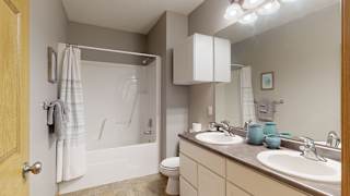 a bathroom with a sink and a shower and a toilet