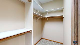 a walk in closet with built-in shelves and hanging space