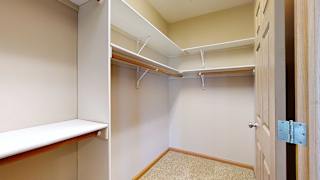 a walk-in closet with built-in shelves and hanging space