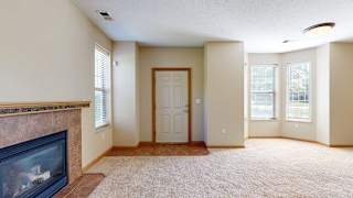 a living room with a fireplace and a front door