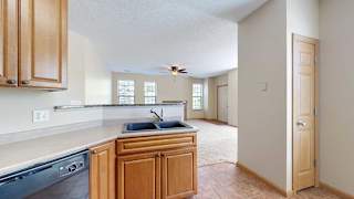 a kitchen with a swan stone sink and a pantry door