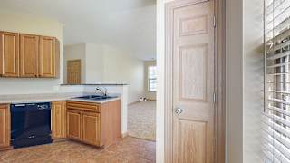a kitchen with a pantry door next to a window