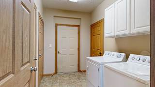 a laundry room with white appliances and a door to the garage