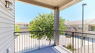 the view from the corner balcony with a tree that provides privacy