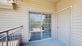 a balcony with outdoor storage closet and sliding glass door