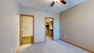 a bedroom with an attached bathroom and a walk-in closet