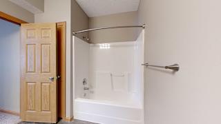 a bathroom with a shower tub and mechanical closet