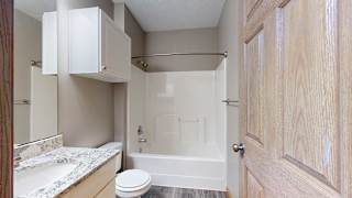 a bathroom with a shower tub and a sink and a toilet