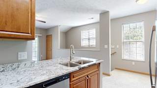 a kitchen peninsula with a sink with granite counter tops