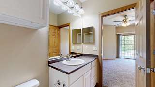 a bathroom with a vanity sink and a mirror with overhead lights